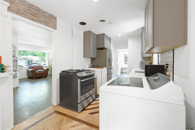 11103 Tascosa St, Dallas, TX 75228 - kitchen featuring washer / dryer, gray cabinetry, stainless steel gas stove, light wood-style flooring, and recessed lighting