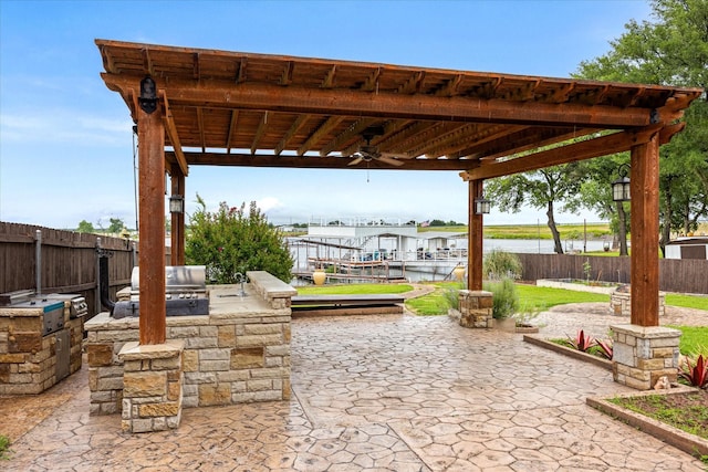 122 County Road 603, Eastland, TX 76448 - fenced backyard featuring ceiling fan, a patio, and a water view