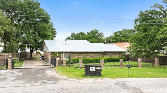 122 County Road 603, Eastland, TX 76448 - ranch-style house featuring a gate, metal roof, and driveway