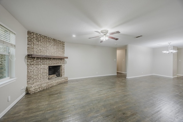 1624 Summer Place Cir, Irving, TX 75062 - unfurnished living room with a ceiling fan, a brick fireplace, a chandelier, wood finished floors, and baseboards