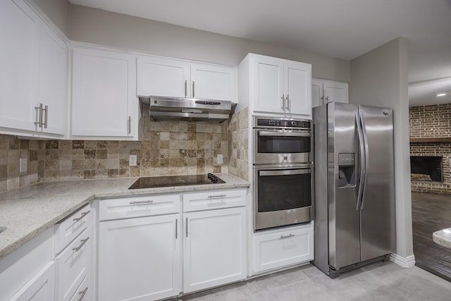1624 Summer Place Cir, Irving, TX 75062 - kitchen featuring stainless steel appliances, under cabinet range hood, light stone countertops, and white cabinets