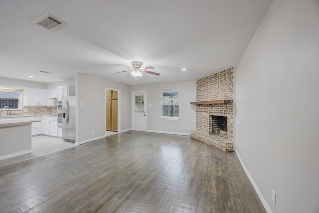 1624 Summer Place Cir, Irving, TX 75062 - unfurnished living room featuring ceiling fan, healthy amount of natural light, a fireplace, a sink, and recessed lighting