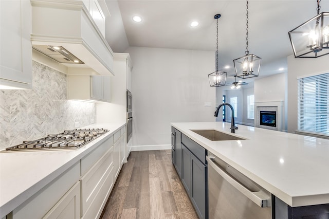 8532 Melrose, The Colony, TX 75056 - kitchen featuring appliances with stainless steel finishes, a chandelier, an island with sink, dark wood-style flooring, and recessed lighting