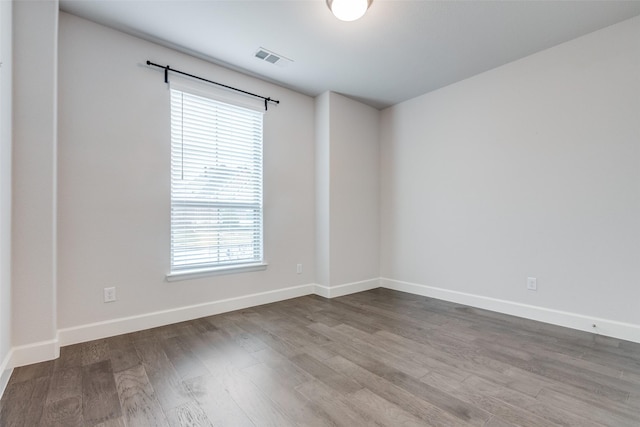 8532 Melrose, The Colony, TX 75056 - spare room with plenty of natural light, wood finished floors, and baseboards