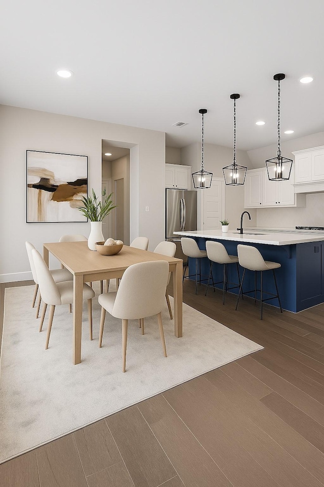 8532 Melrose, The Colony, TX 75056 - dining space featuring wood finished floors and recessed lighting