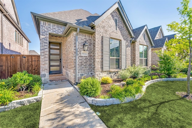 8532 Melrose, The Colony, TX 75056 - view of front of house with brick siding and roof with shingles