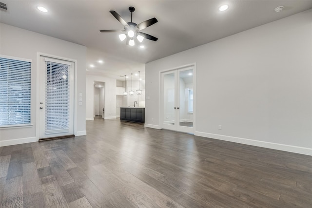 8532 Melrose, The Colony, TX 75056 - unfurnished living room featuring ceiling fan, dark wood-style flooring, baseboards, french doors, and recessed lighting