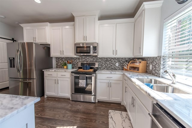 411 Sterling Shores Dr, Scroggins, TX 75480 - kitchen featuring stainless steel appliances, white cabinets, decorative backsplash, dark wood-style flooring, and recessed lighting