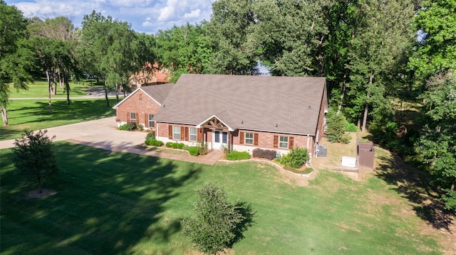 411 Sterling Shores Dr, Scroggins, TX 75480 - view of front of home featuring brick siding, a front yard, and view of scattered trees