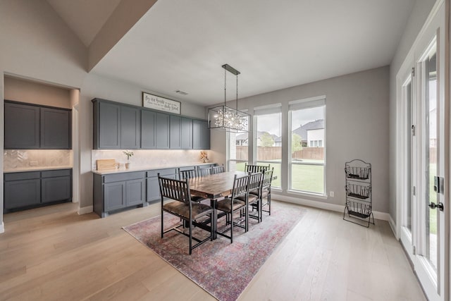 562 Broadleaf Way, Haslet, TX 76052 - dining area featuring light wood-type flooring, baseboards, and a chandelier