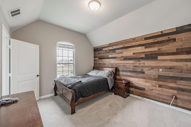 562 Broadleaf Way, Haslet, TX 76052 - bedroom with wood walls, vaulted ceiling, and light colored carpet