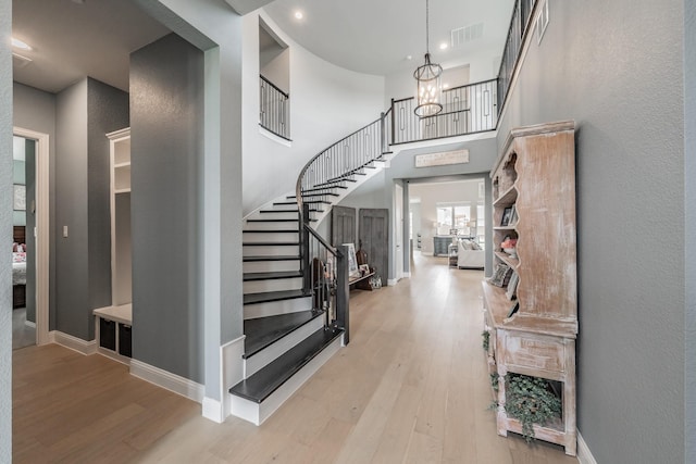 562 Broadleaf Way, Haslet, TX 76052 - foyer entrance with wood finished floors, stairway, a chandelier, baseboards, and a high ceiling