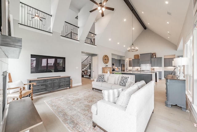 562 Broadleaf Way, Haslet, TX 76052 - living area featuring ceiling fan, high vaulted ceiling, stairs, beam ceiling, and a chandelier