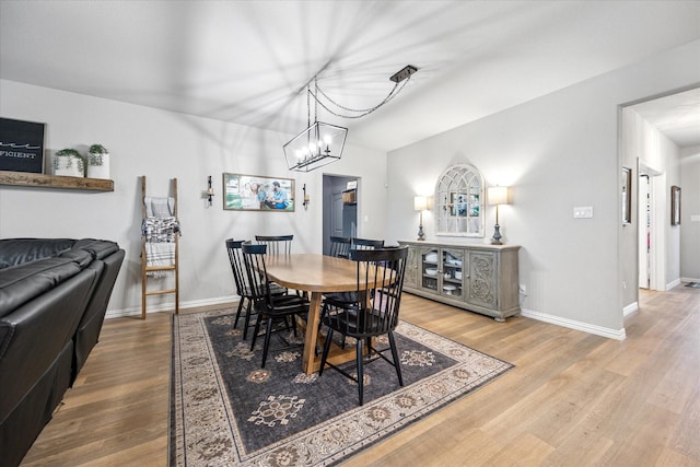 168 Ridgetop Trl, Rhome, TX 76078 - dining area with wood finished floors, baseboards, and a chandelier