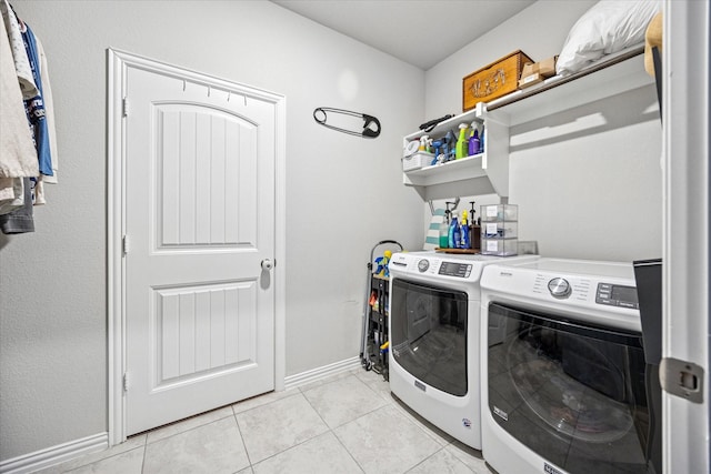168 Ridgetop Trl, Rhome, TX 76078 - laundry room featuring washer and clothes dryer, baseboards, and light tile patterned flooring