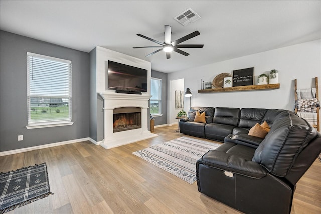 168 Ridgetop Trl, Rhome, TX 76078 - living area with ceiling fan, wood finished floors, a fireplace, and baseboards