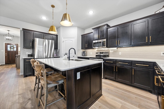 168 Ridgetop Trl, Rhome, TX 76078 - kitchen with a sink, stainless steel appliances, decorative backsplash, a breakfast bar, and light wood finished floors