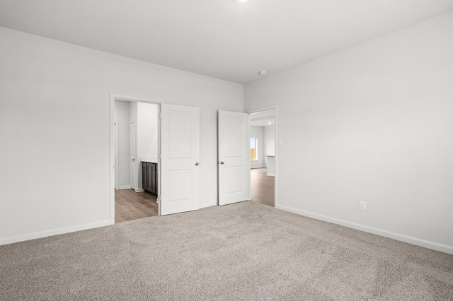 426 Gib Woodall Dr, Venus, TX 76084 - unfurnished bedroom with carpet floors, baseboards, and ensuite bath