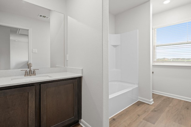 426 Gib Woodall Dr, Venus, TX 76084 - bathroom with vanity, wood finished floors, shower / washtub combination, and baseboards