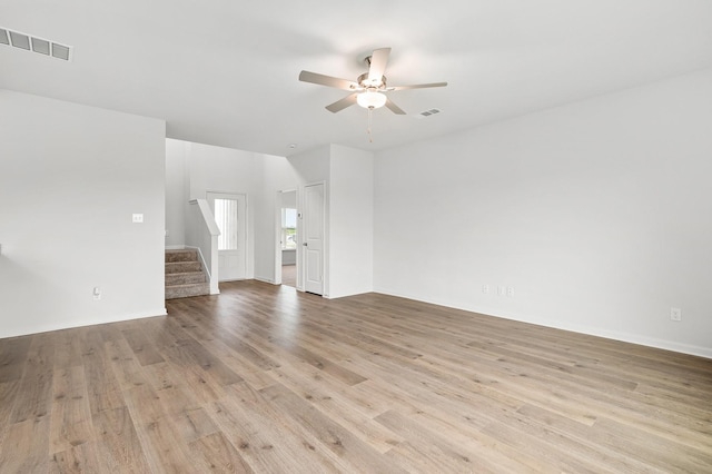 426 Gib Woodall Dr, Venus, TX 76084 - unfurnished living room featuring a ceiling fan, stairs, light wood-style floors, and baseboards