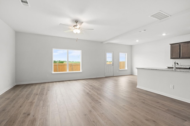 426 Gib Woodall Dr, Venus, TX 76084 - unfurnished living room with a ceiling fan, light wood-type flooring, a sink, baseboards, and recessed lighting