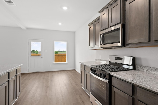 426 Gib Woodall Dr, Venus, TX 76084 - kitchen with stainless steel appliances, dark brown cabinets, light wood-style floors, light stone countertops, and recessed lighting