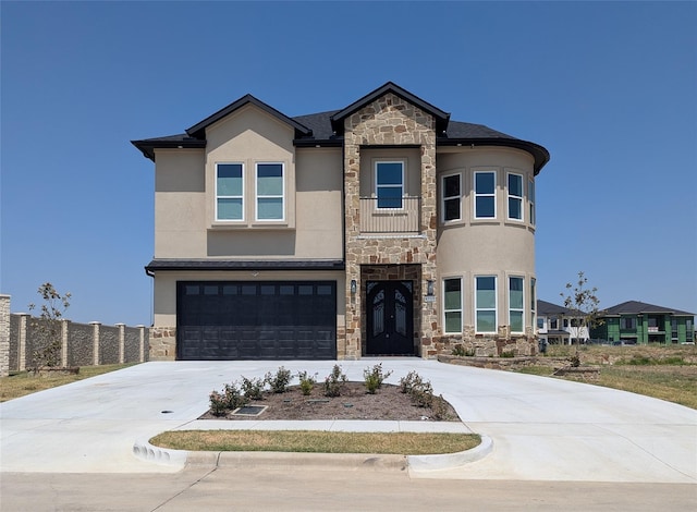 4715 Glavica Dr, Irving, TX 75062 - view of front of property with stone siding, stucco siding, an attached garage, and driveway