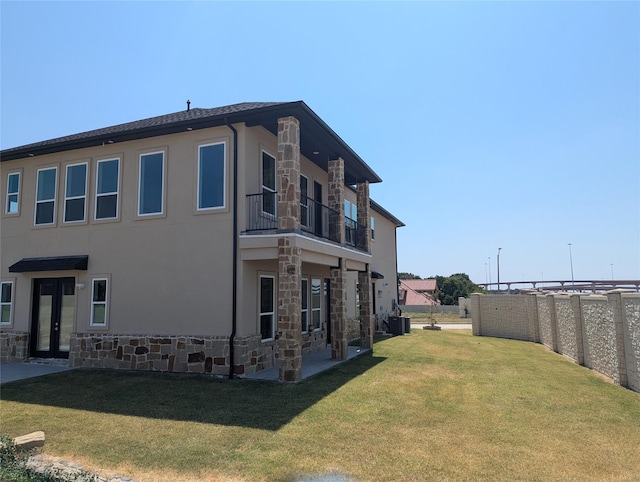 4715 Glavica Dr, Irving, TX 75062 - view of property exterior with stone siding, a balcony, french doors, and central AC unit