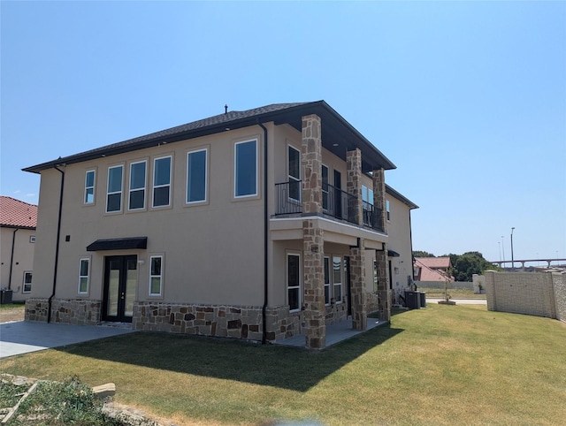 4715 Glavica Dr, Irving, TX 75062 - rear view of house featuring stone siding, a balcony, french doors, central AC, and a patio area