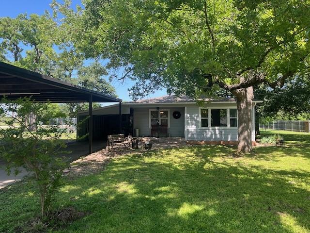 214 Hemphill St, Hico, TX 76457 - rear view of house featuring a carport