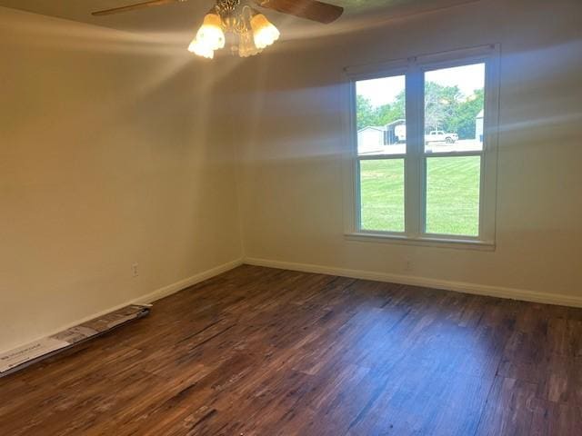 214 Hemphill St, Hico, TX 76457 - unfurnished room with a ceiling fan, dark wood-type flooring, plenty of natural light, and baseboards