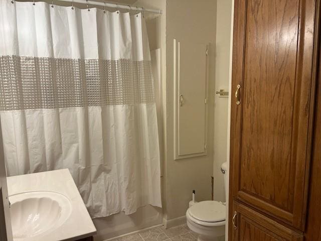 214 Hemphill St, Hico, TX 76457 - bathroom with toilet, vanity, shower / bathtub combination with curtain, baseboards, and tile patterned floors