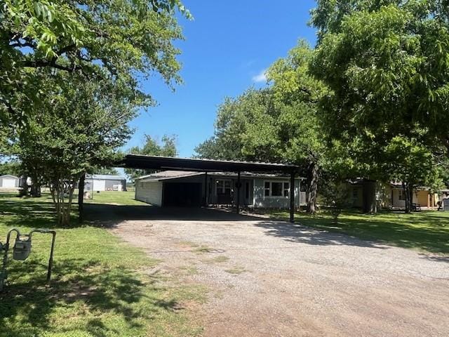 214 Hemphill St, Hico, TX 76457 - view of front of house featuring asphalt driveway, a front yard, and a carport