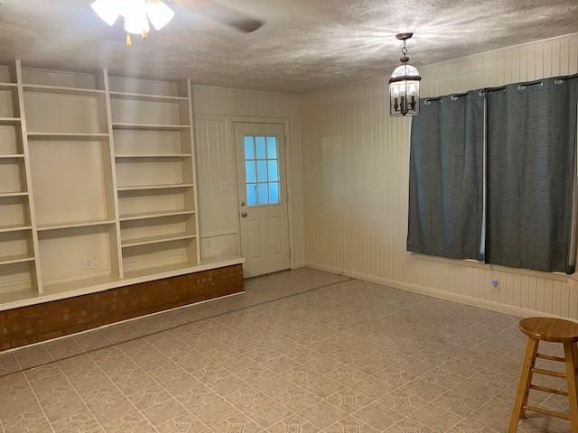 214 Hemphill St, Hico, TX 76457 - unfurnished dining area featuring a ceiling fan, baseboards, and a chandelier