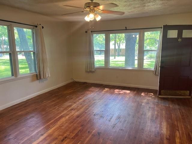 214 Hemphill St, Hico, TX 76457 - unfurnished room featuring ceiling fan, wood-type flooring, baseboards, and healthy amount of natural light