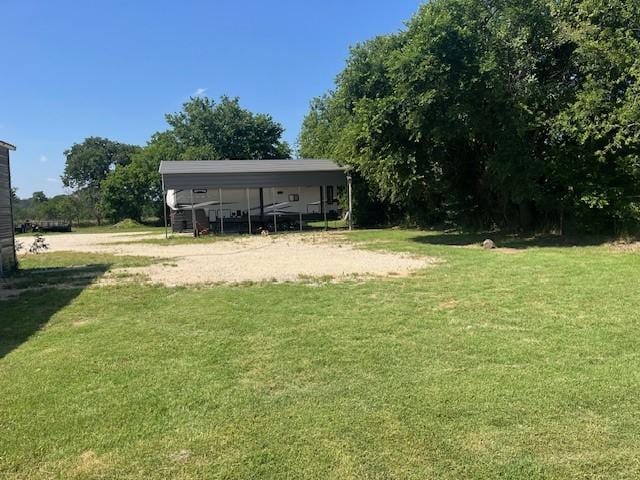 214 Hemphill St, Hico, TX 76457 - view of grassy yard featuring a carport