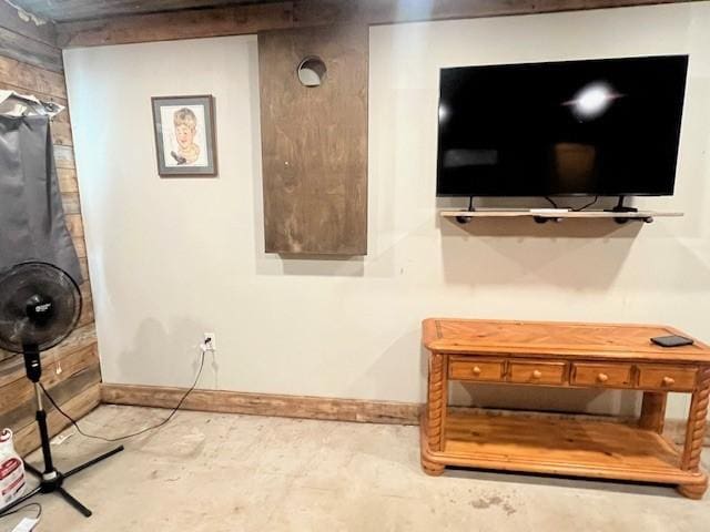 214 Hemphill St, Hico, TX 76457 - living room featuring baseboards and unfinished concrete flooring