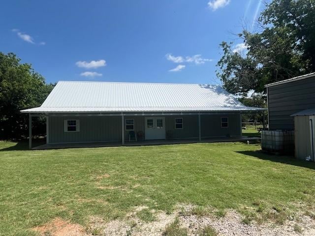 214 Hemphill St, Hico, TX 76457 - back of property featuring a lawn and metal roof
