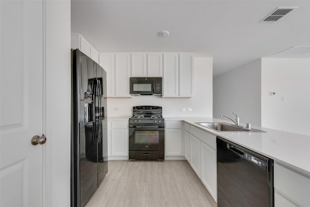 2037 Welsh Ln, Aubrey, TX 76227 - kitchen featuring black appliances, a sink, white cabinetry, and light countertops