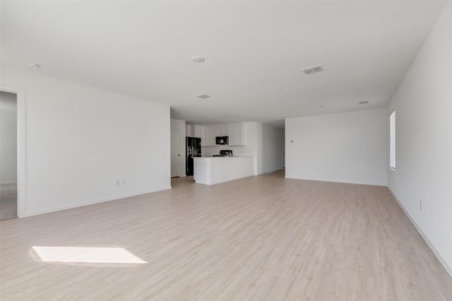 2037 Welsh Ln, Aubrey, TX 76227 - unfurnished living room with light wood finished floors and baseboards
