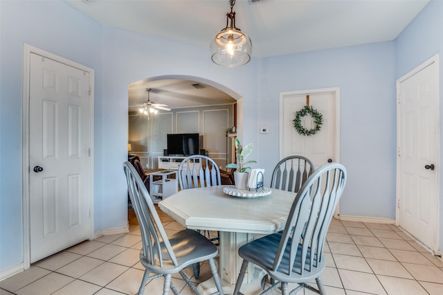 3820 Blossom Dr, Sachse, TX 75048 - dining room featuring arched walkways, a ceiling fan, light tile patterned flooring, and baseboards