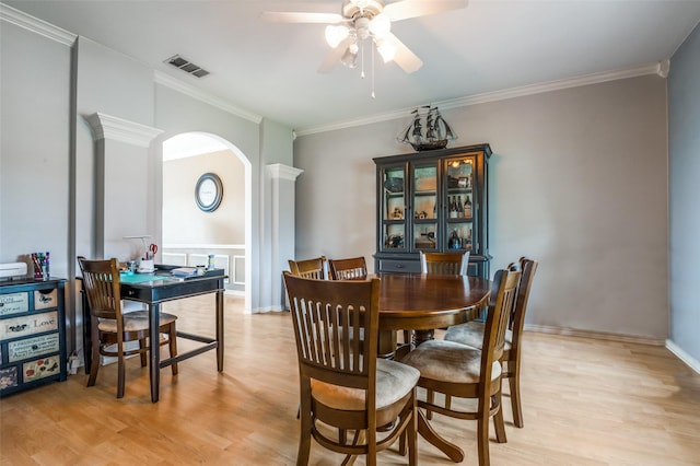3820 Blossom Dr, Sachse, TX 75048 - dining area featuring arched walkways, ceiling fan, light wood-style floors, and ornamental molding