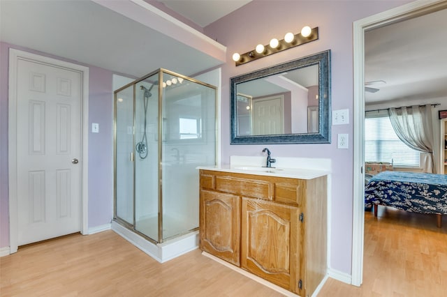 3820 Blossom Dr, Sachse, TX 75048 - ensuite bathroom with a stall shower, wood finished floors, vanity, and baseboards