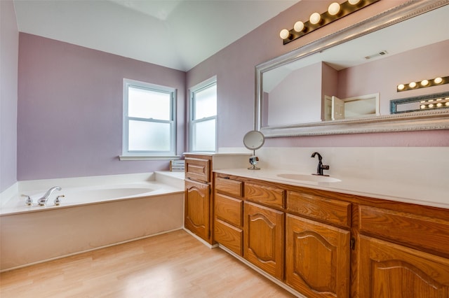 3820 Blossom Dr, Sachse, TX 75048 - full bath with wood finished floors, vanity, and a garden tub
