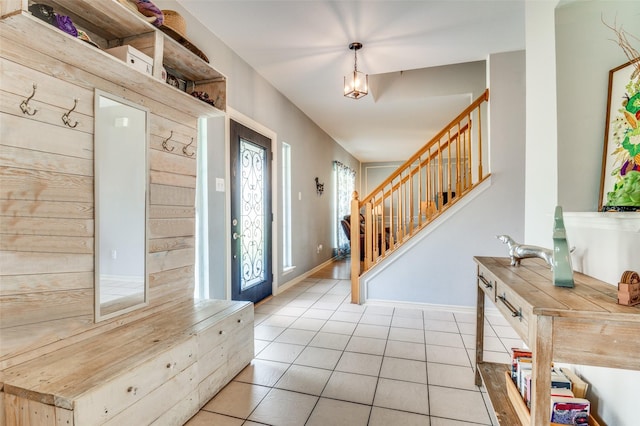 3820 Blossom Dr, Sachse, TX 75048 - foyer featuring light tile patterned flooring, stairs, a chandelier, and baseboards