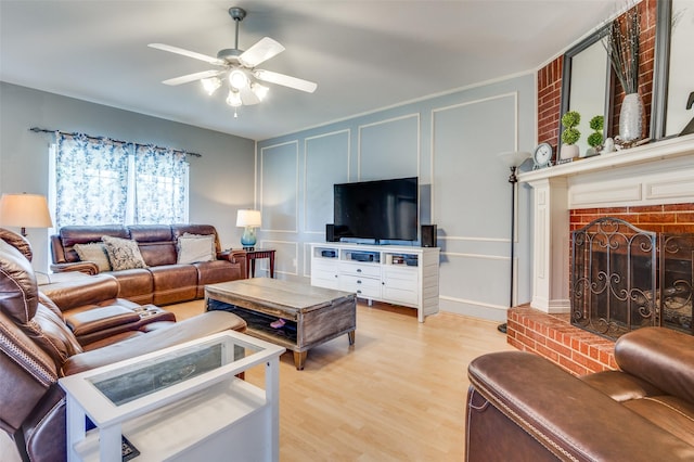 3820 Blossom Dr, Sachse, TX 75048 - living area featuring ceiling fan, light wood-type flooring, a decorative wall, and a brick fireplace
