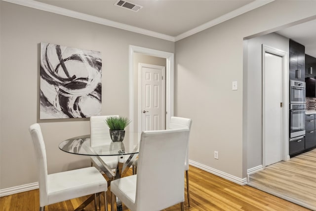 9705 Ash Creek Dr, Dallas, TX 75228 - dining room with light wood-style floors, baseboards, and crown molding