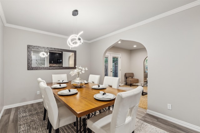 9705 Ash Creek Dr, Dallas, TX 75228 - dining room with arched walkways, wood finished floors, ornamental molding, and a chandelier