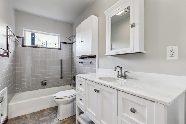 9705 Ash Creek Dr, Dallas, TX 75228 - bathroom featuring vanity, shower / bathtub combination, toilet, and stone finish floors
