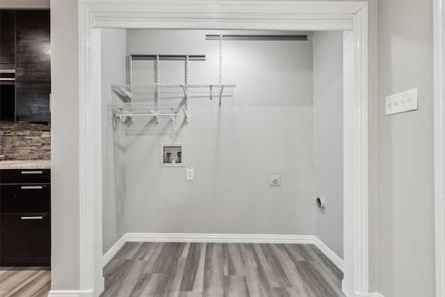 9705 Ash Creek Dr, Dallas, TX 75228 - laundry area with wood finished floors, baseboards, washer hookup, and hookup for an electric dryer